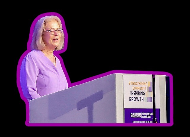 photo of woman at podium, glowing purple