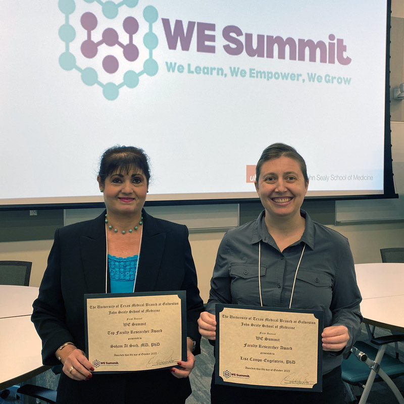 photo of two people holding awards