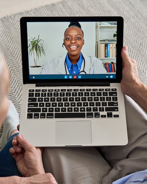 laptop showing a woman of color healthcare worker