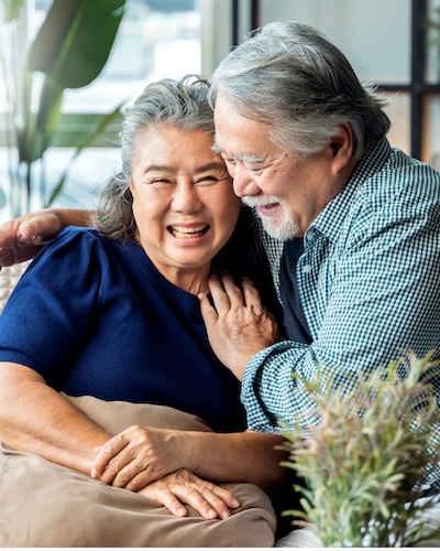 older adult couple hugging