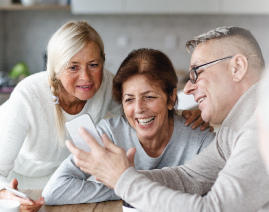 three older adults using smartphones