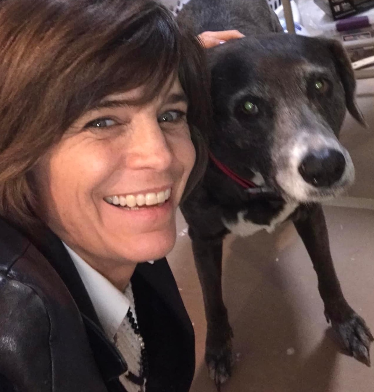 middle aged woman smiling with dog