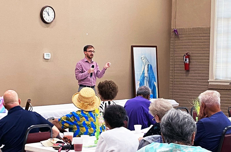 photo of man presenting to group at a church