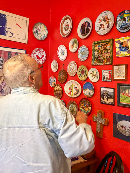 Bets Anderson, an older adult, looks at her art collection 