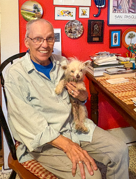 Bets Anderson, an older adult, poses with her pet dog in her home