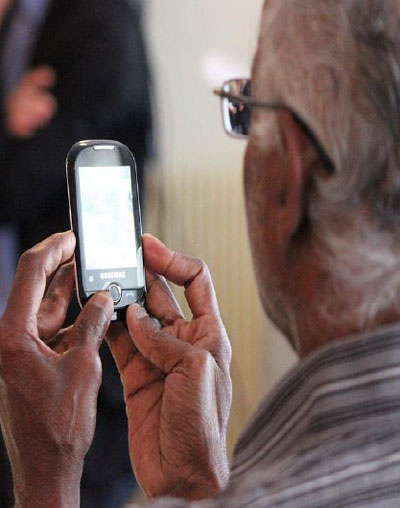 photo of older man using a cell phone