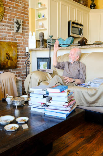 Uli Budelmann Dr. Budelmann sits on a couch being interviewed, raising his arm