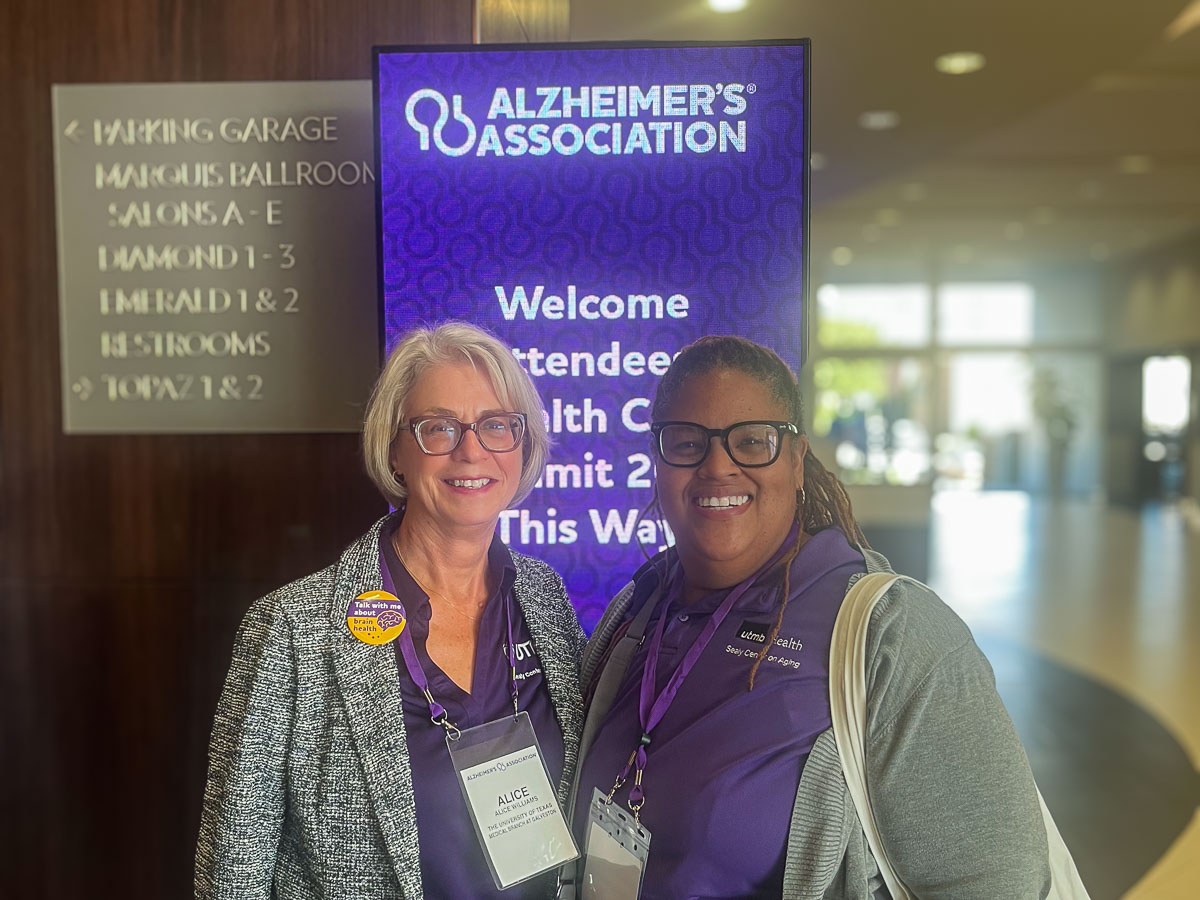 two women wearing purple