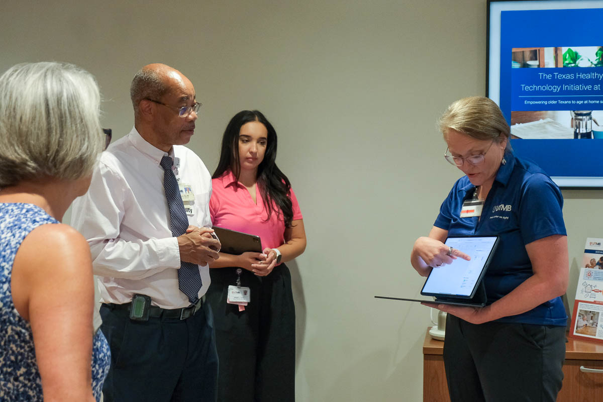 Dr Morrow showing info on a laptop