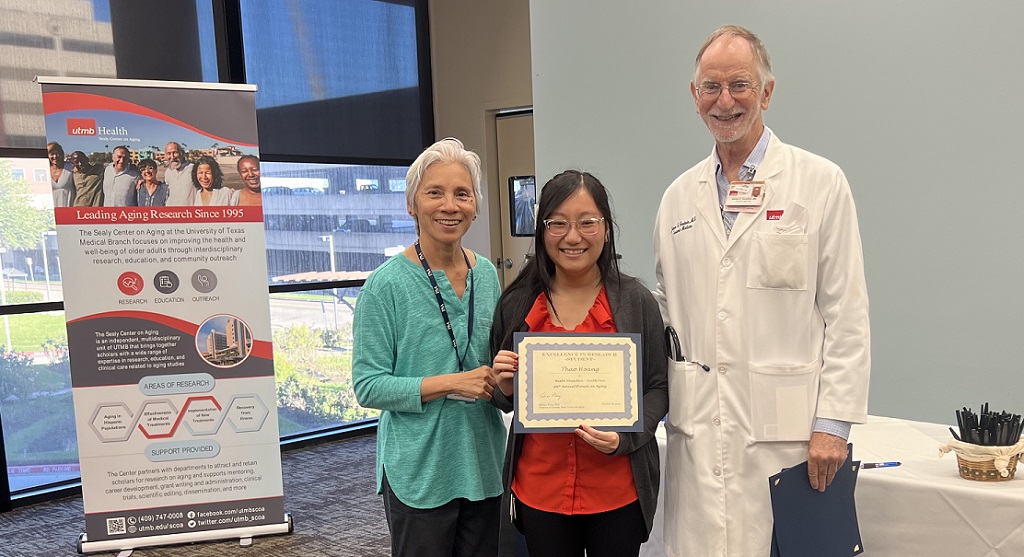 Award presentation to Thao Hoang, standing between Rebecca Wong and James Goodwin