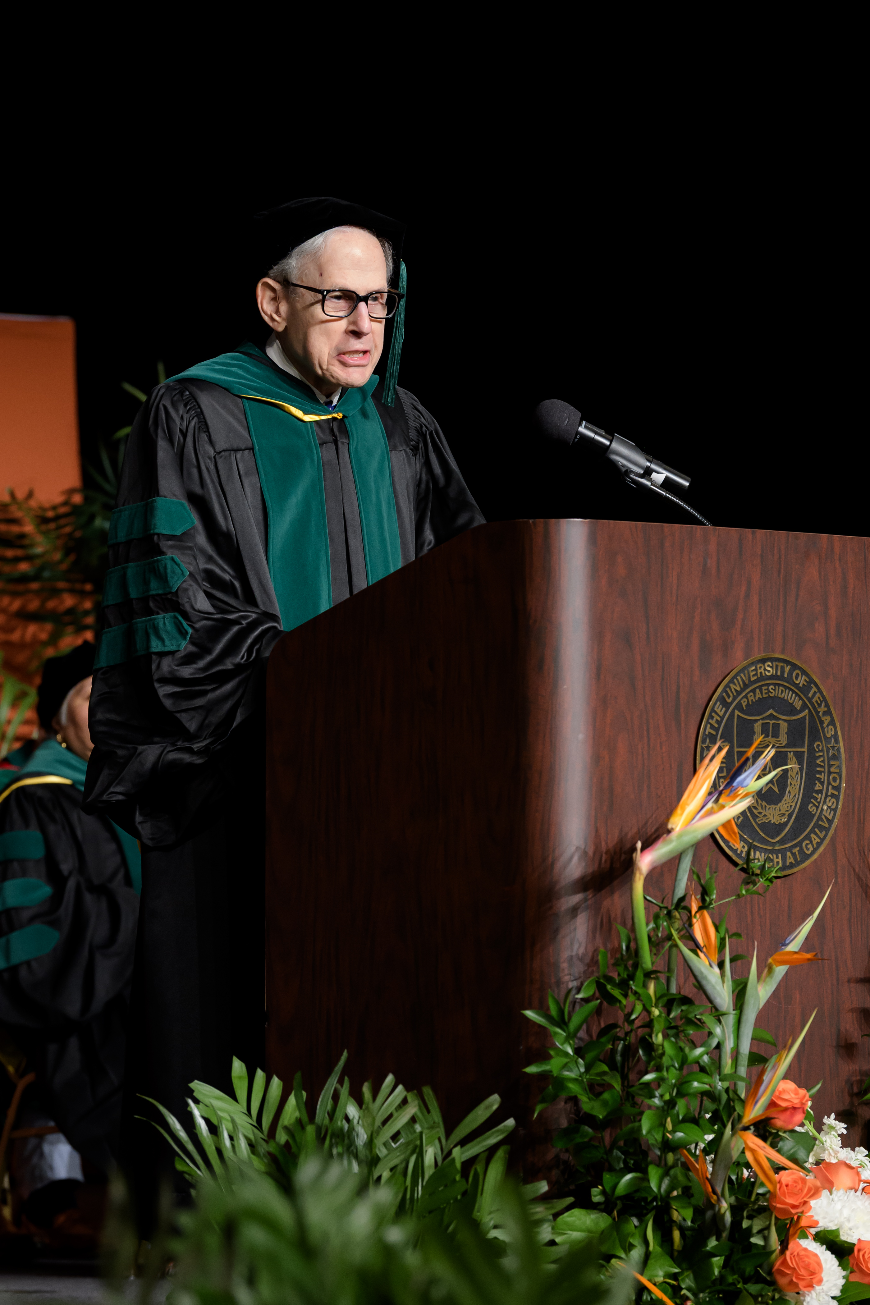 Dr. Coller delivering a speech at the 2026 JSSOM MD Commencement