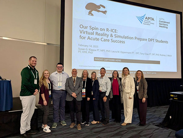 UTMB Physical Therapy faculty pose in front of a screen displaying, "Our Spin on R-ICE: Virtual Reality & Simulation Prepare DPT Students for Acute Care Success" at the American Physical Therapy Association Combined Sections Meeting.