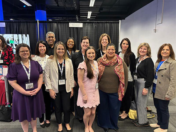 SON faculty, alumni, and students pose in a group photo at the SNRS conference.