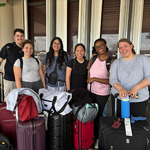 Nursing - Belize 6 A group of nursing students poses with their luggage for the Belize trip stacked in front of them.