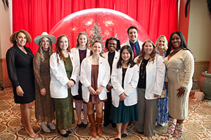 Students and supporters pose together at the Holiday Style event