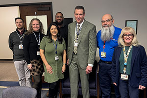 Dr. David Vines poses with staff and leaders from the School of Health Professions