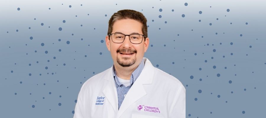 Presenter Adam Wolfe from Baylor College of Medicine. Caucasian male in his 50s with glasses a mustache and cropped beard, brown hair and wearing a white lab coat.