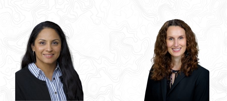 Caitlin Cotter: Caucasian female in her 30s-40s with an oval face, narrow nos, long brown wavy hair, in a black blouse. Mandeep Sandhu. Indian female with long black hair, wearing a stripped blouse and black sweater.