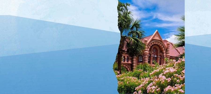 UTMB Old Red historic red brick Romanesque Revival building with flowers for a spring time setting