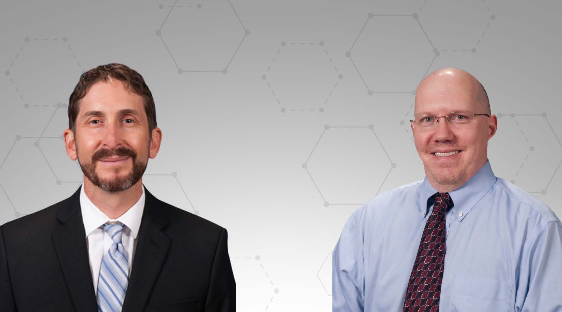 Facilitators: Myron Arnaud & Peter Slivinski. Two Caucasian men. One man in his 40s wearing a black suit and blue tie. He has brown hair, cropped beard and mustache. The 2nd man is in his 50s, bald, no facial hair and glasses in blue shirt and black tie.
