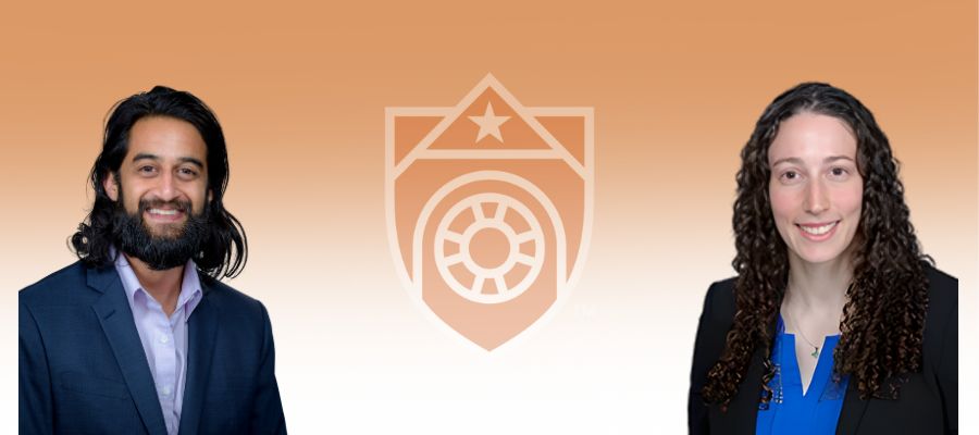 Presenter Ahmar Hashmi, in profile, Arab/Indian male in his 30s with long black hair beard and mustache in a blue suit . Co presenter Corri Levine, white female in her 30s with long black curly hair in a black suit. Both a smiling.