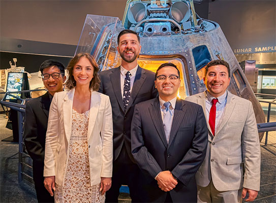 The five 2025 Aerospace Medicine residency graduates pose during their graduation at Space Center Houston.
