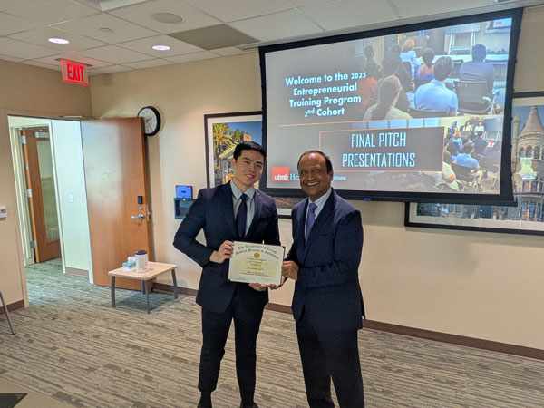 Dr. Vineet Gupta presents a certificate to an ETP student