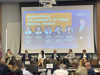 A panel of UTMB leaders sits in chairs on stage