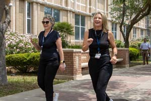 IMG_3952_1 Dr. Susan Chubinskaya and Julie Griffith walking in front of the Galveston National Lab