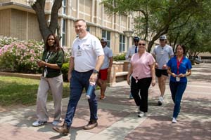 IMG_3969_1 A group of UTMB employees walking in front of the Galveston National Lab