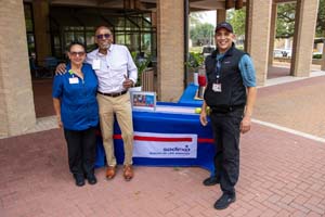 IMG_3975_1 Sodexo representatives pose in front of their table, which has a blue table cover and company logo