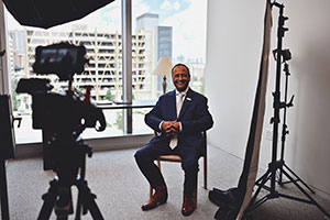 Dr. Vineet Gupta is sitting in front of a camera as if preparing for a photo or video shoot