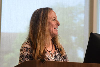 keynote Dr. Katherine Tuttle is standing at a podium speaking