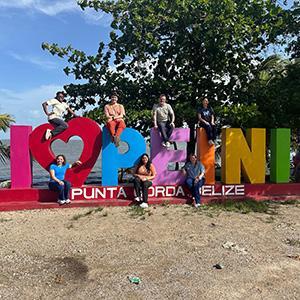 Nursing - Belize 3 A group of nursing students and Dr. Zach Carson pose on sculpted letters that spell out