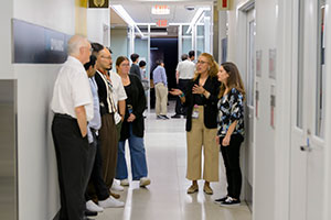 SIDD personnel, right, offer a lab tour to open house visitors.