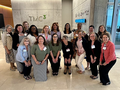TEACH-S Photos 2025 UTMB Group-reduced A group of UTMB educators and peers from other institutions pose together in front of the TMC3 signage at the TEACH-S symposium