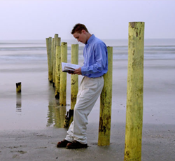 Student standing on the beach