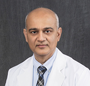 Picture of a man wearing a white coat and tie