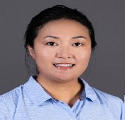 Picture of a woman smiling wearing a light blue shirt