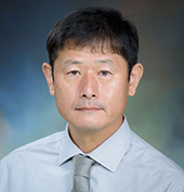 Picture of a man wearing a blue shirt and tie