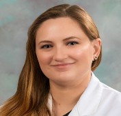 Picture of a woman wearing a white lab coat