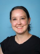 Image of a lady smiling in a black shirt