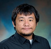 Picture of a man wearing a navy shirt