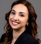Picture of a woman smiling with curly brown hair