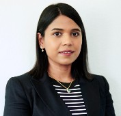 Picture of a woman wearing a navy blazer and striped navy and white shirt