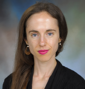 Picture of a woman with dark brown hair and pink lipstick