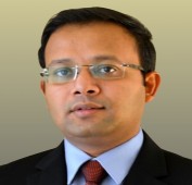 Picture of a man in a suit wearing glasses