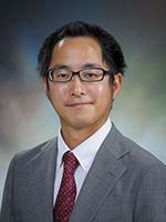 Picture of a man wearing glasses in a suit