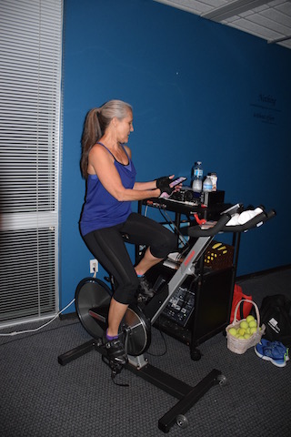 Visor picks out a music playlist for her morning cycling class