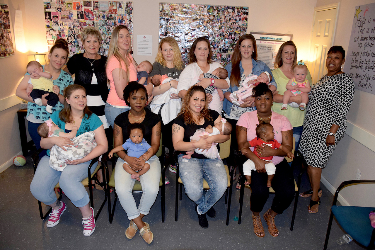 Liz Moore (back row, second from left) and BAMBI case manager Jo Ann Marshall (right), with BAMBI participants and their babies.